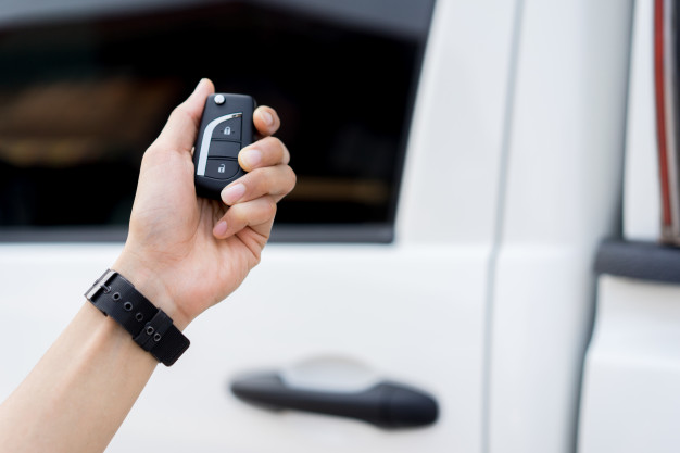 driver man hand holding keyless autonomous car unlock via wireless technology 42708 412