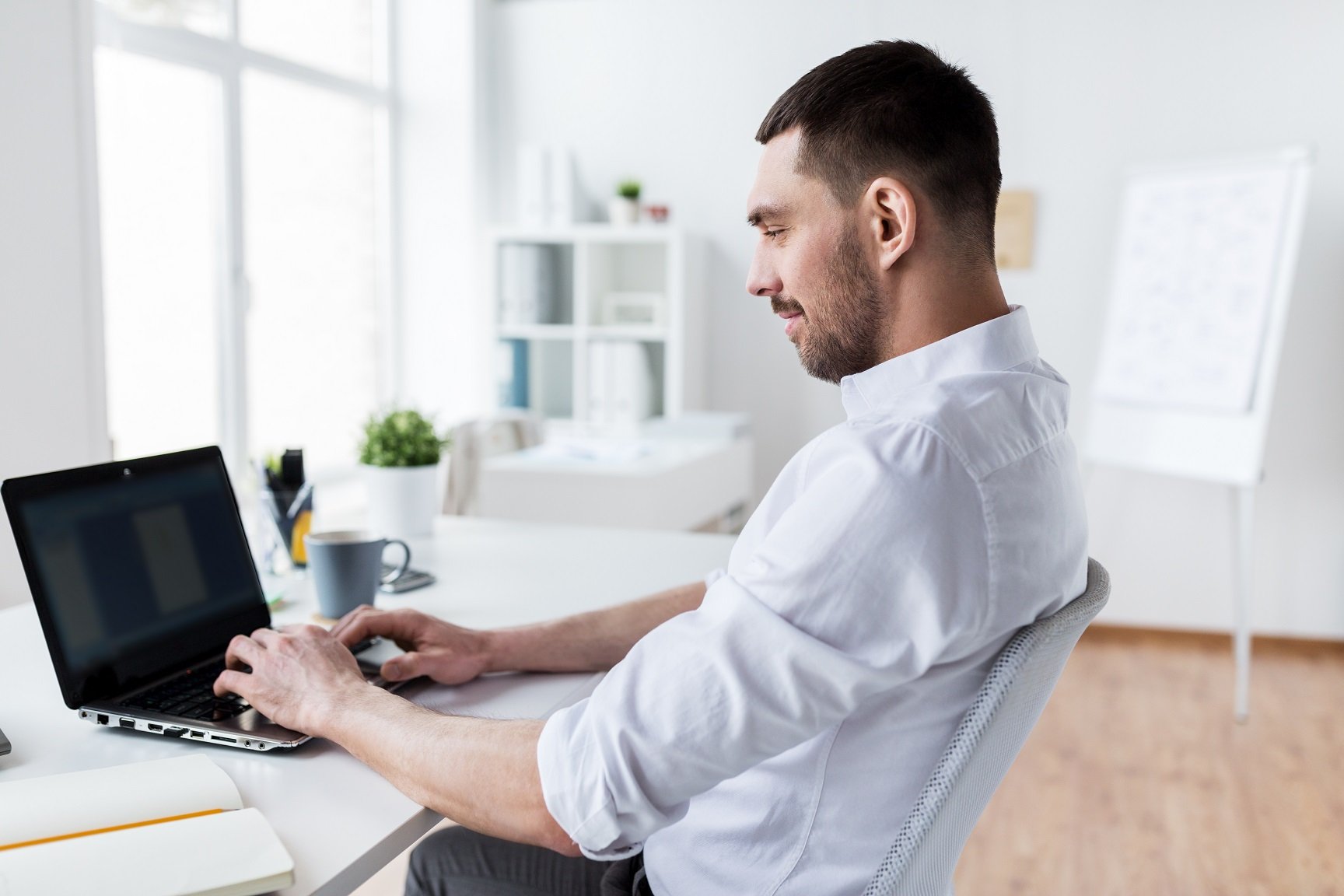 businessman typing on laptop at office