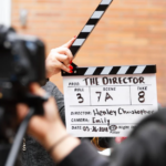 Man holding a clapperboard board