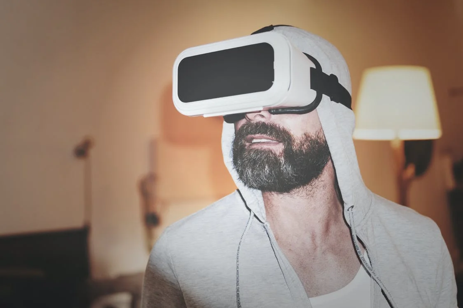 Man in gray hoodie and white virtual reality headset